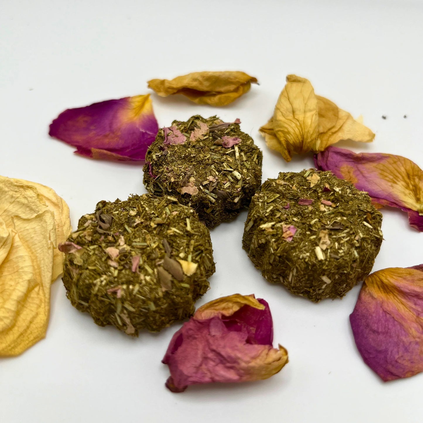 Rabbit and small pet treats on dried petals on a white background