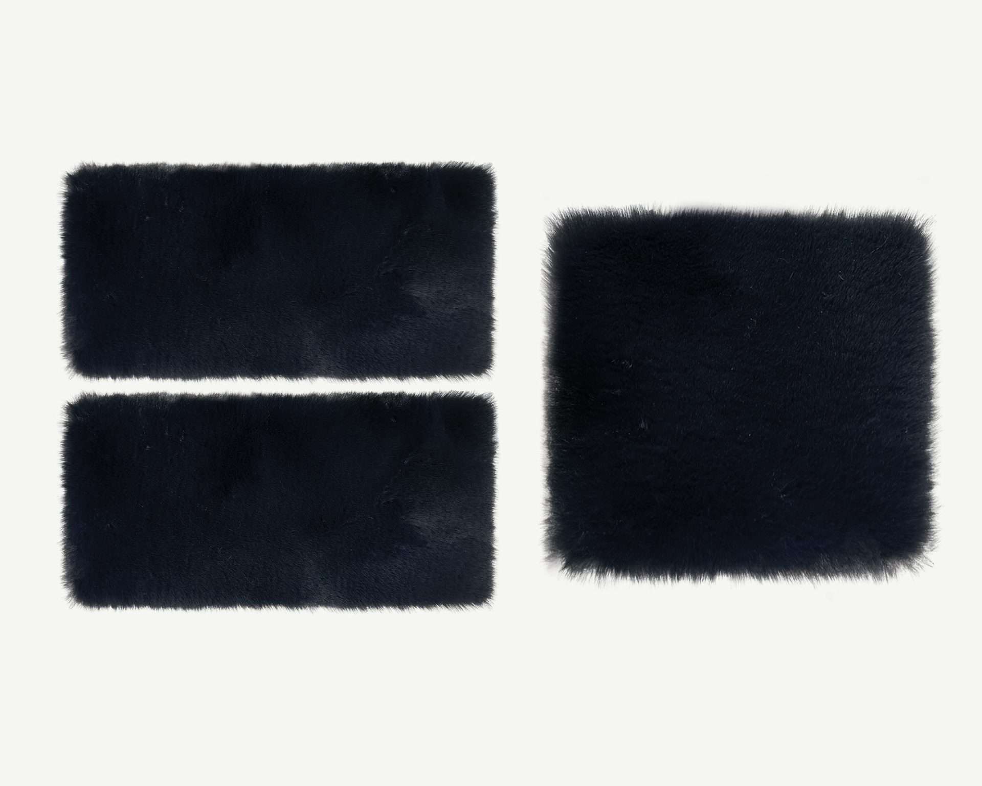 Three black rectangular faux fur patches on a white background