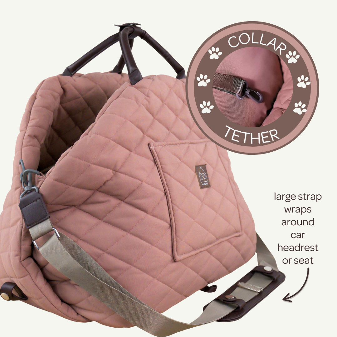 Pink pet car seat with collar tether feature on a white background