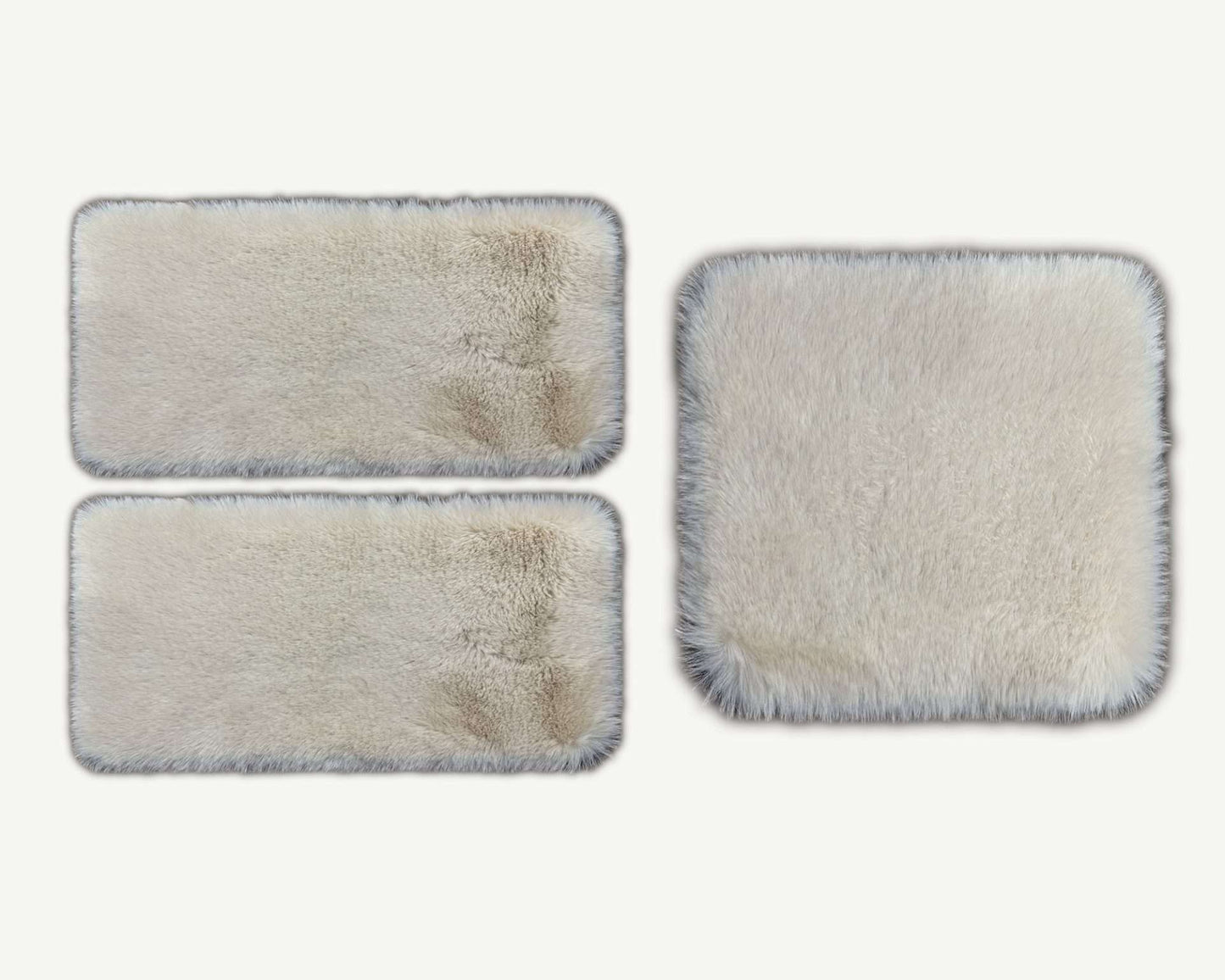 Three rectangular cleaning pads with varying degrees of dirt on a white background