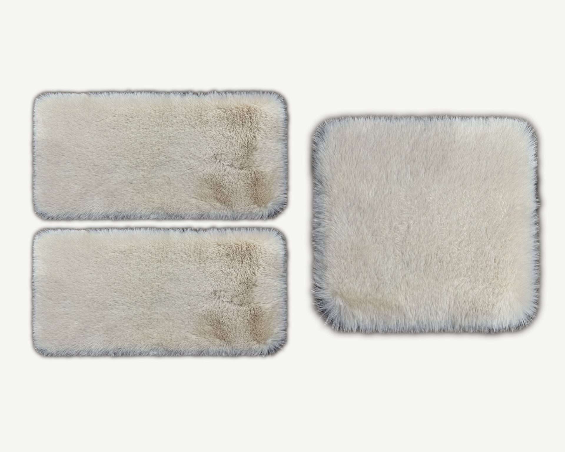 Three rectangular cleaning pads with varying degrees of dirt on a white background