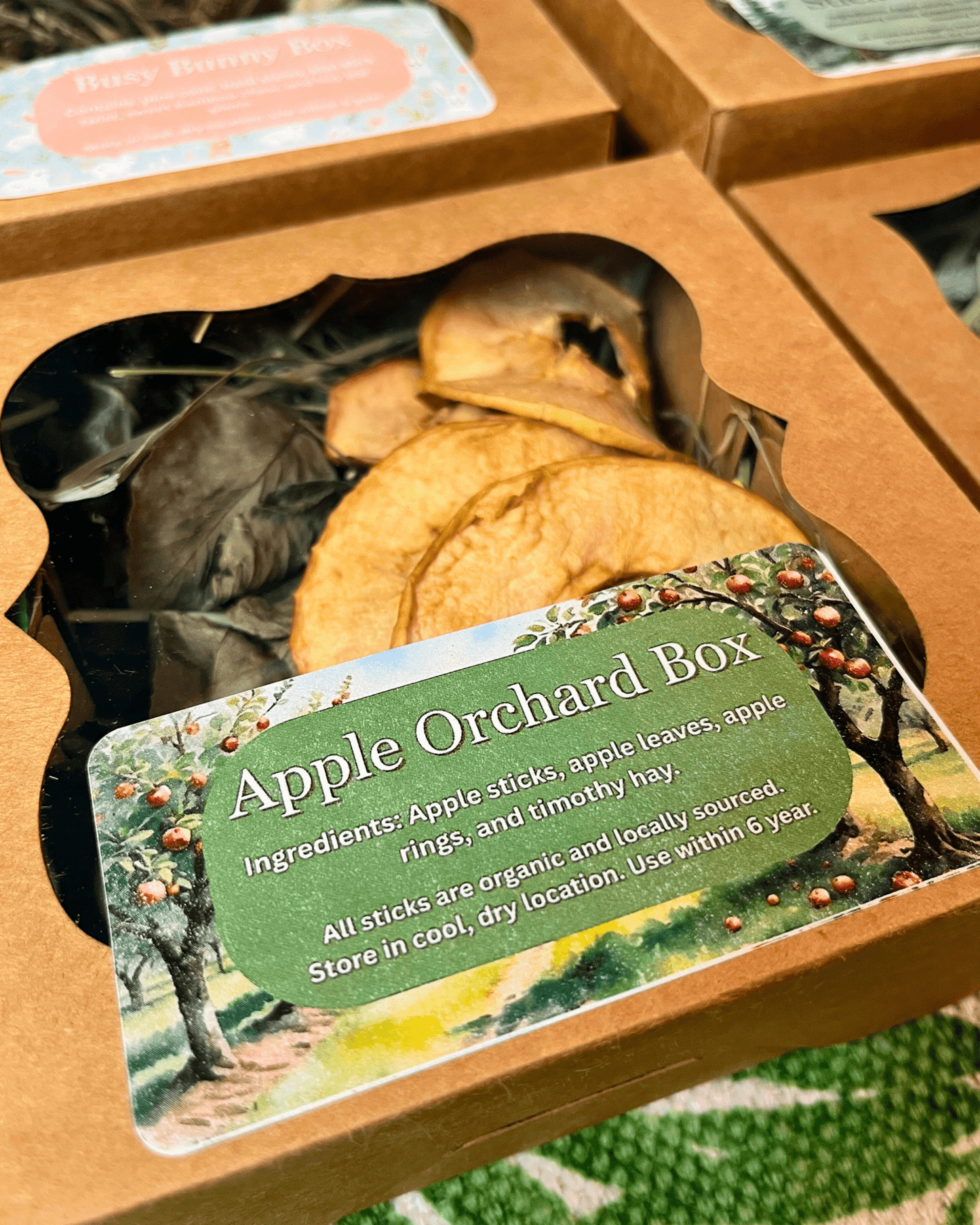 Apple orchard-themed product packaging with a label detailing ingredients and care instructions.