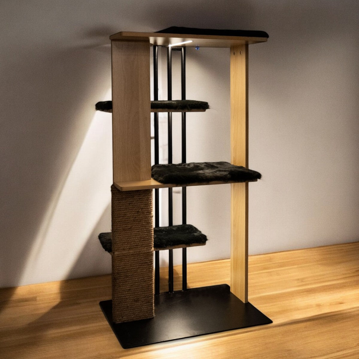 Cat tree with multiple levels and a scratching post on a wooden floor.