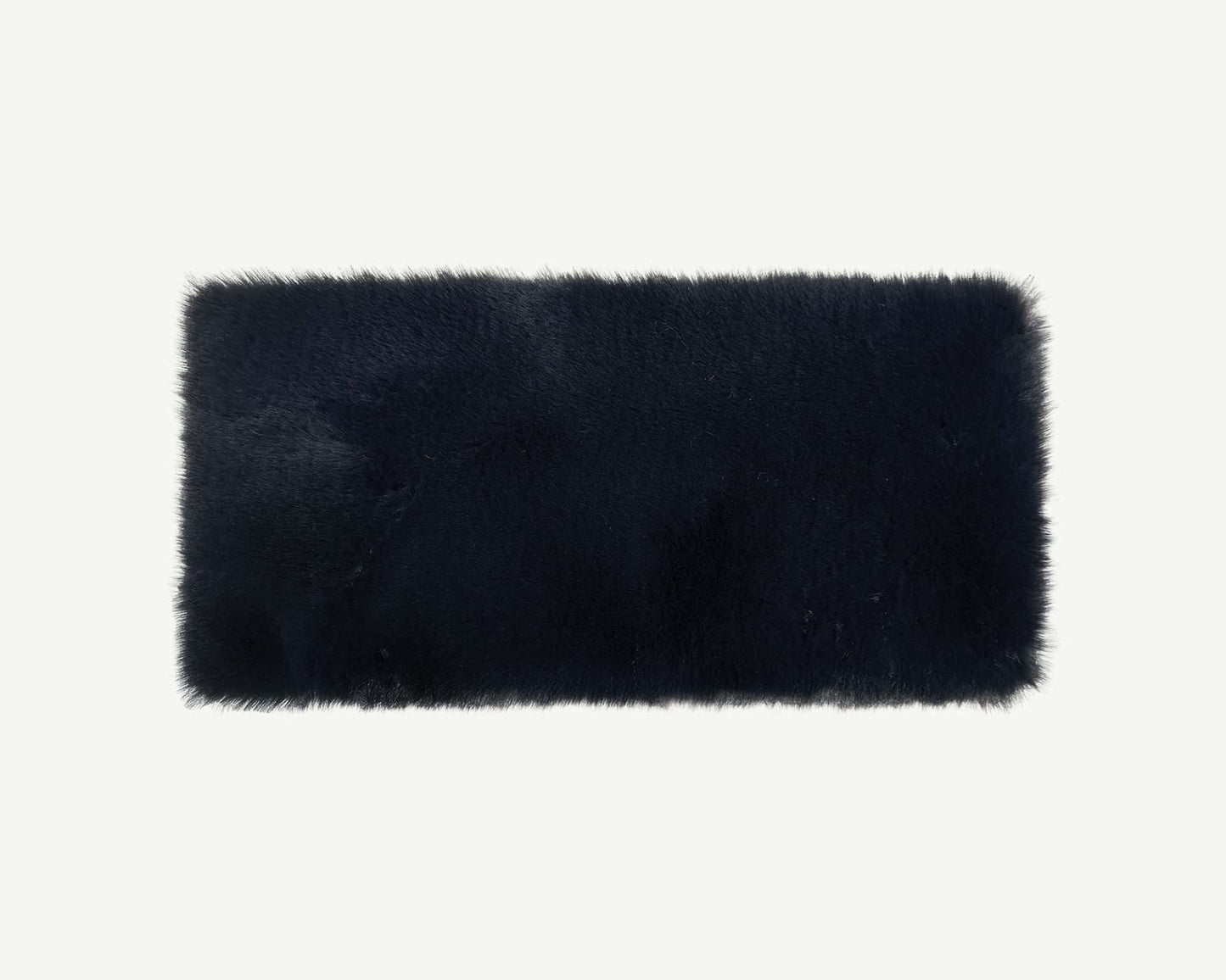 Black rectangular fur rug on a white background