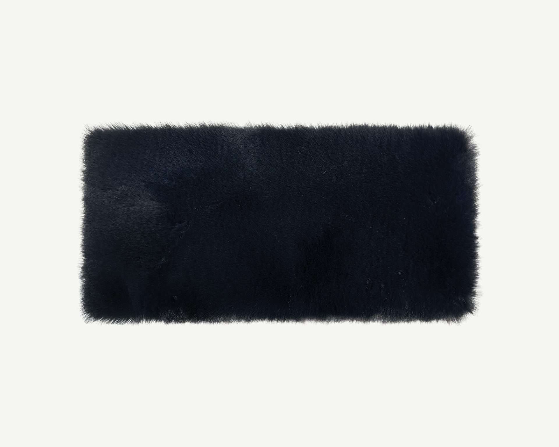 Black rectangular fur rug on a white background