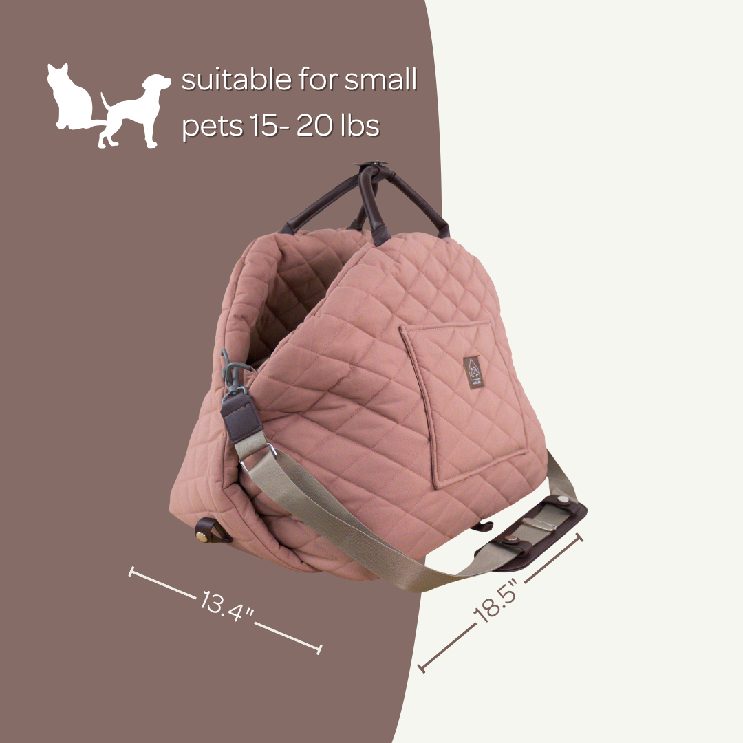 Pink pet carrier with dimensions on a brown background