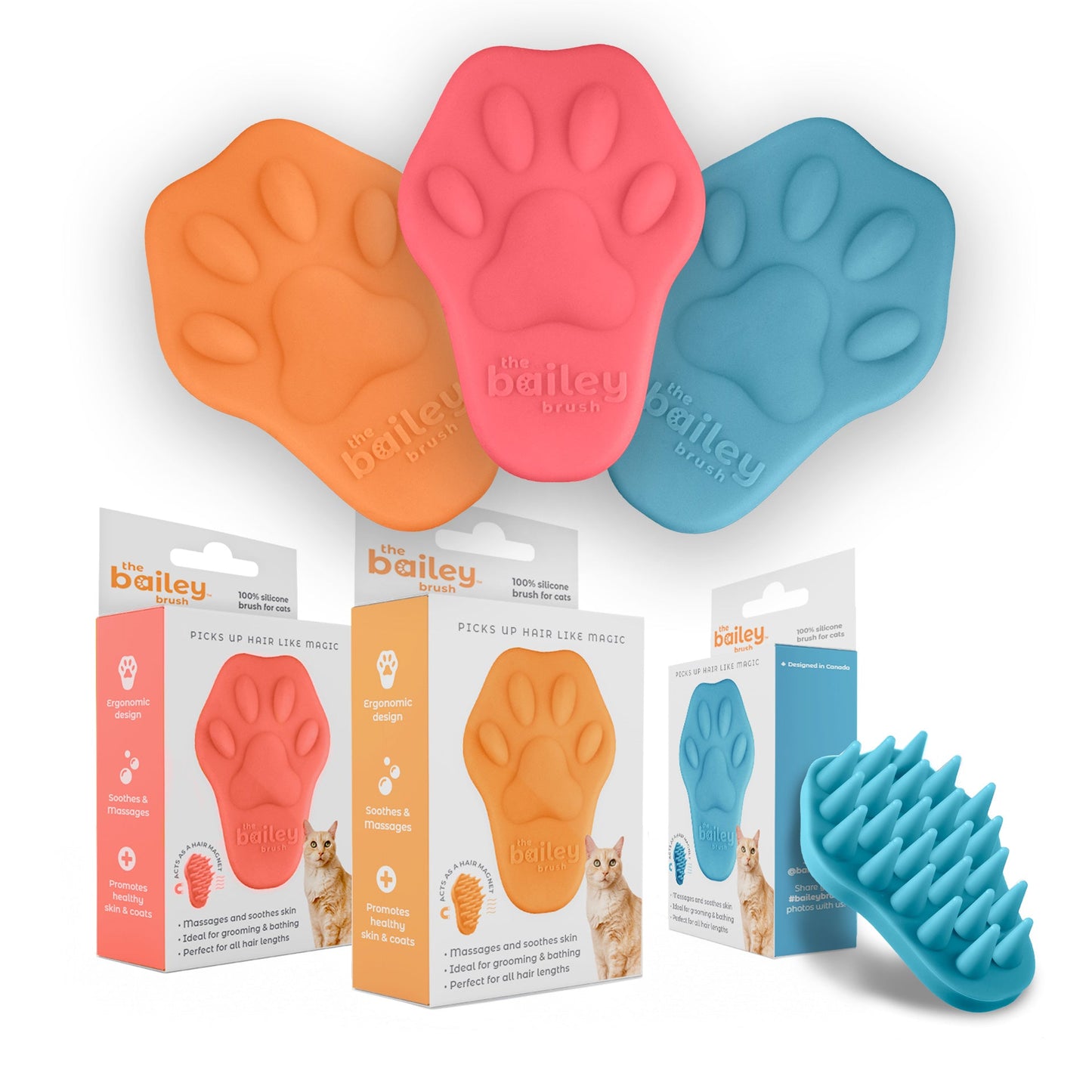 Three paw-shaped pet grooming tools in orange, pink, and blue with packaging and a brush on a white background.