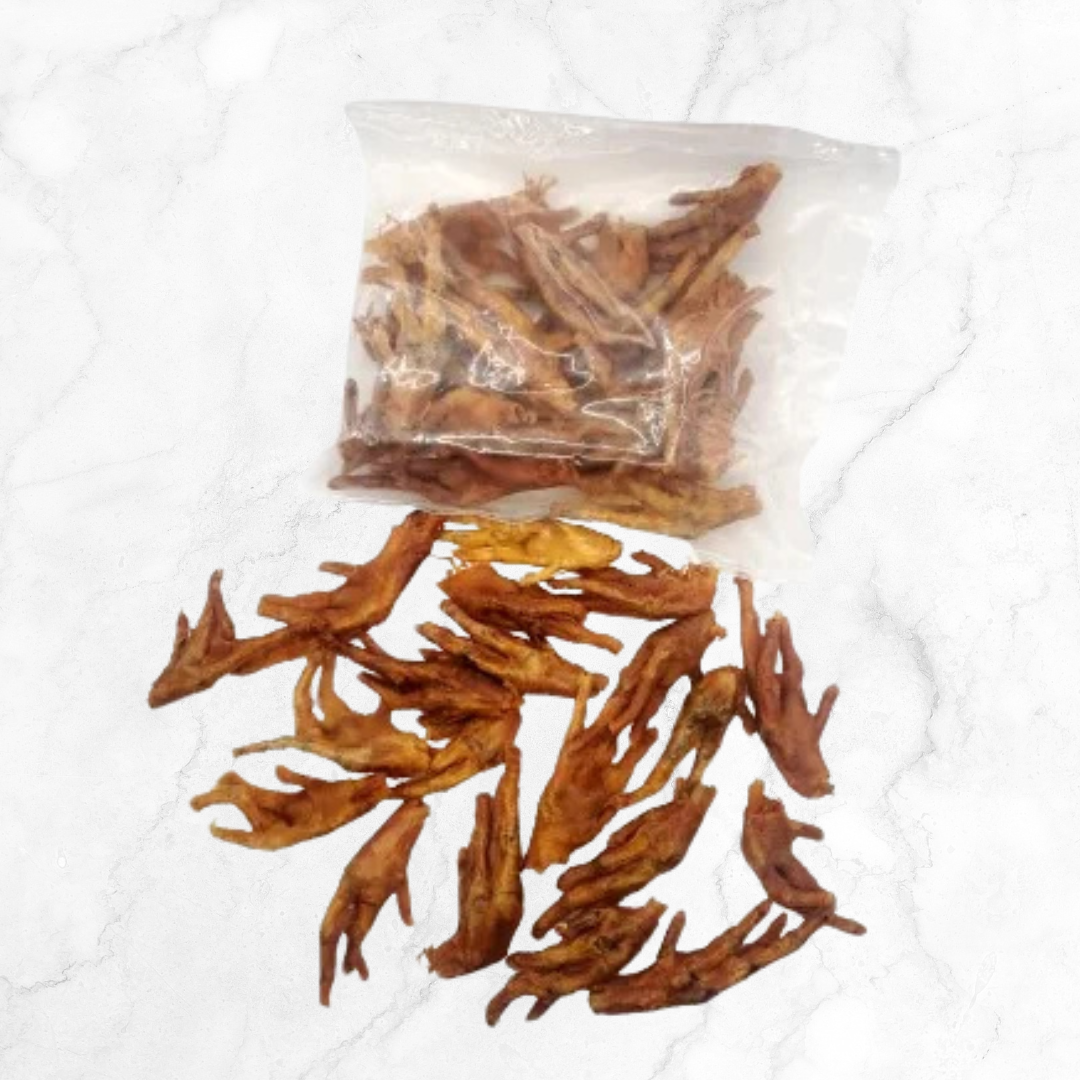 Dried chicken feet with a clear plastic bag on a white background