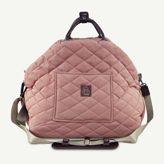 Quilted pink backpack with a visible brand logo on a light gray background