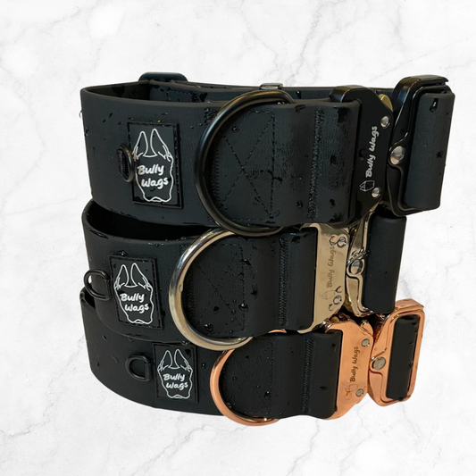 A tower of 2" waterproof dog collars with rose gold, black, and silvler hardware on a white background