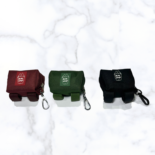 three dog waste bag holders in red, green, black with velcro straps and clip.