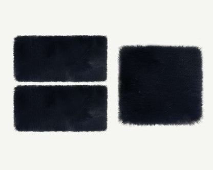 Three black rectangular faux fur patches on a white background