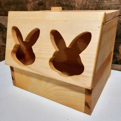 Wooden box with rabbit ear cutouts on a white surface