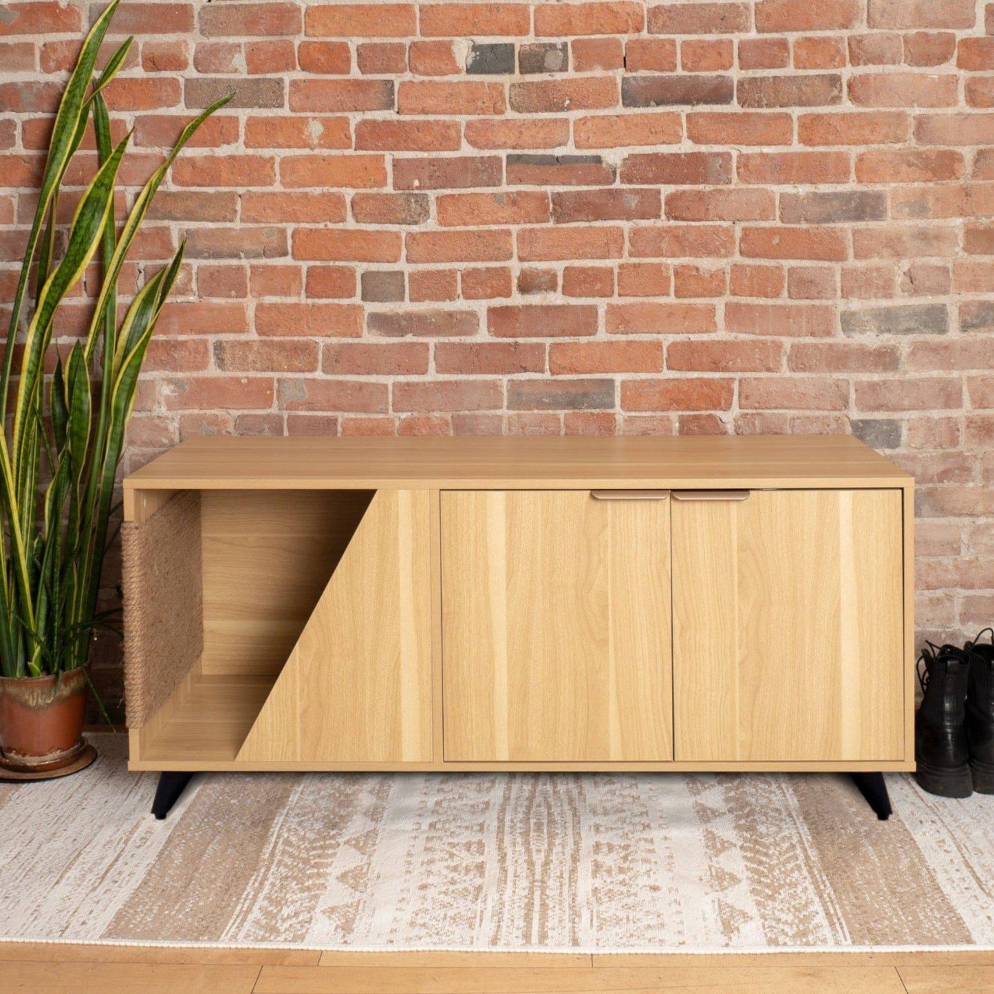 Wooden cabinet with sliding doors against a brick wall
