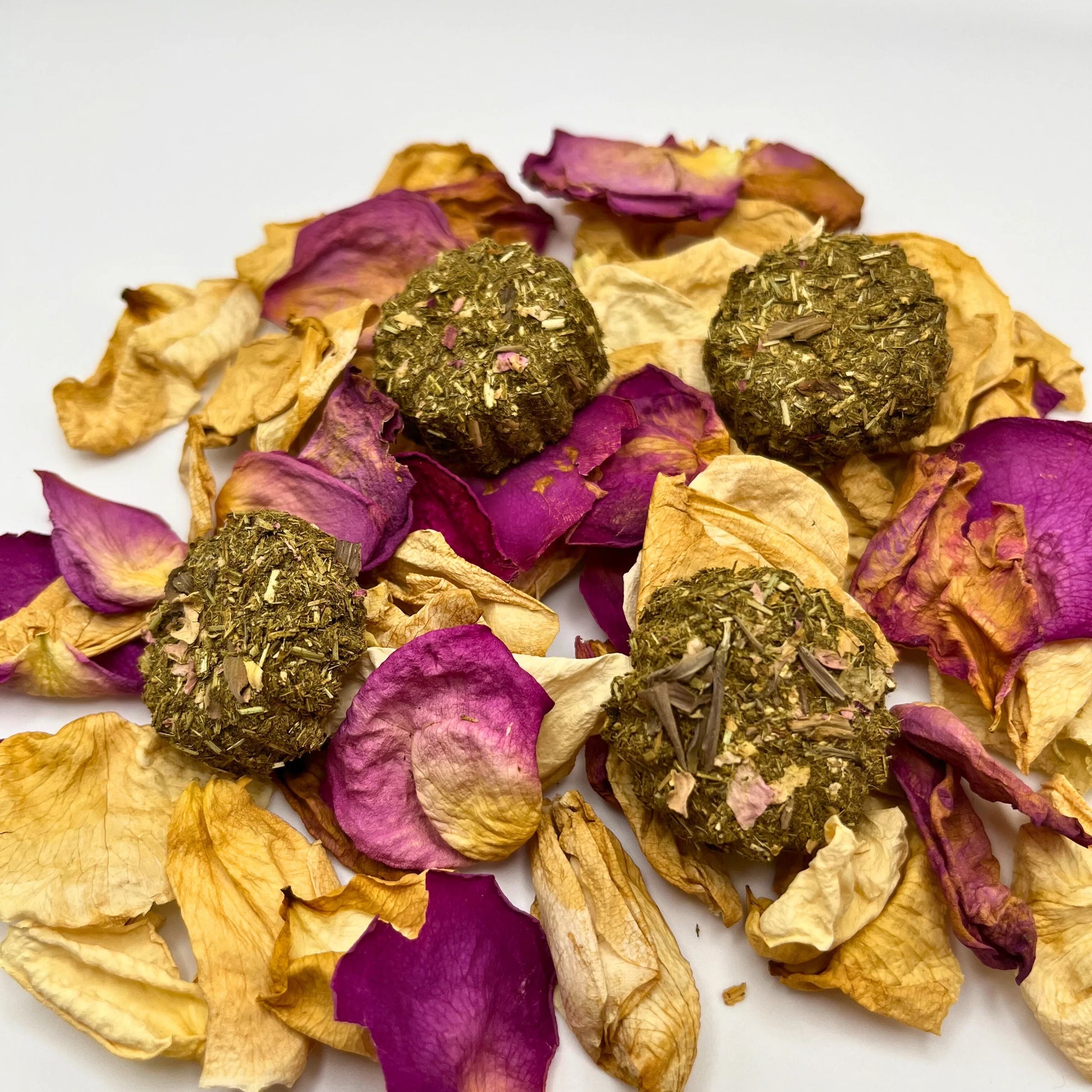 Crunchy all natural rabbit treats on dried petals on a white background