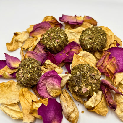 Crunchy all natural rabbit treats on dried petals on a white background