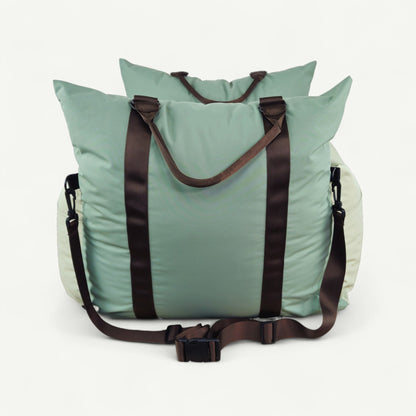Light blue tote bag with brown straps on a white background