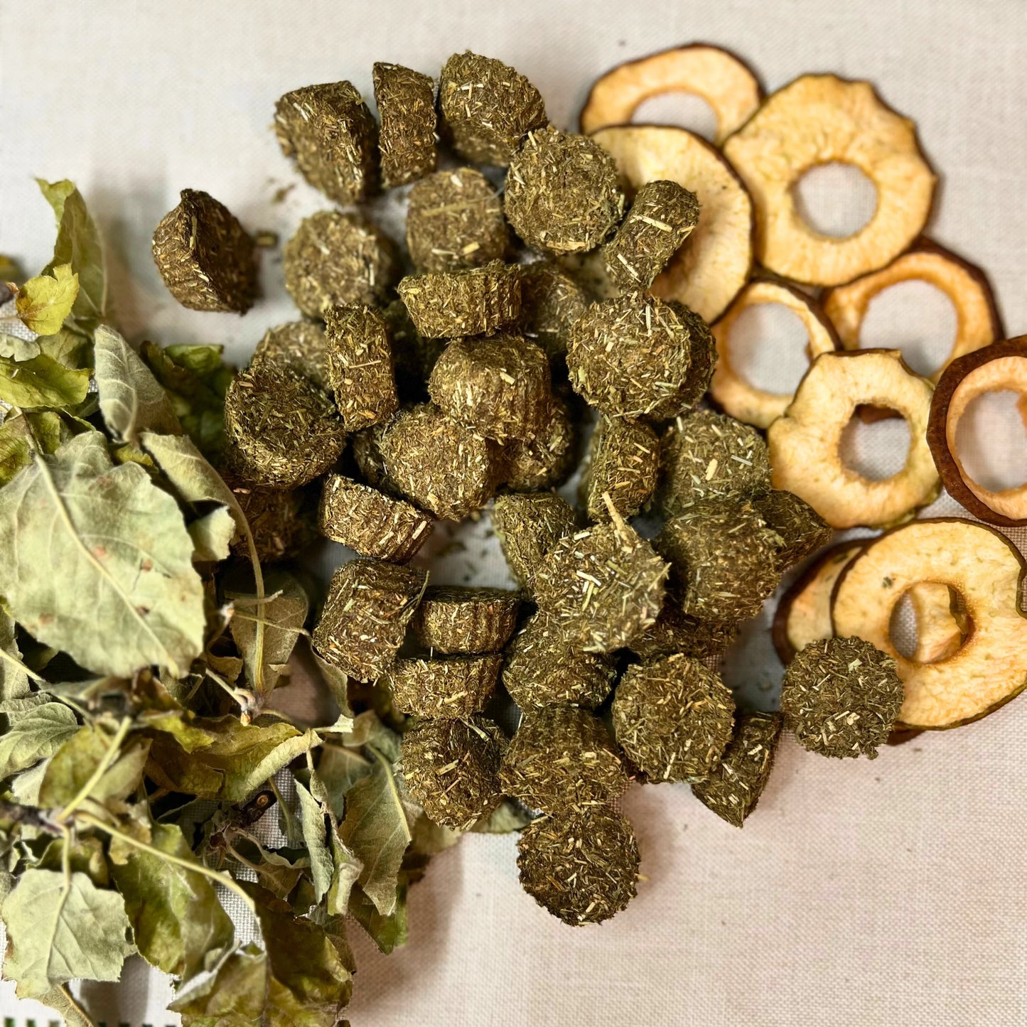 Herbal ingredients including dried leaves, cubes, and slices on a textured surface