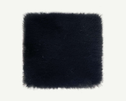 Black faux fur square on a white background