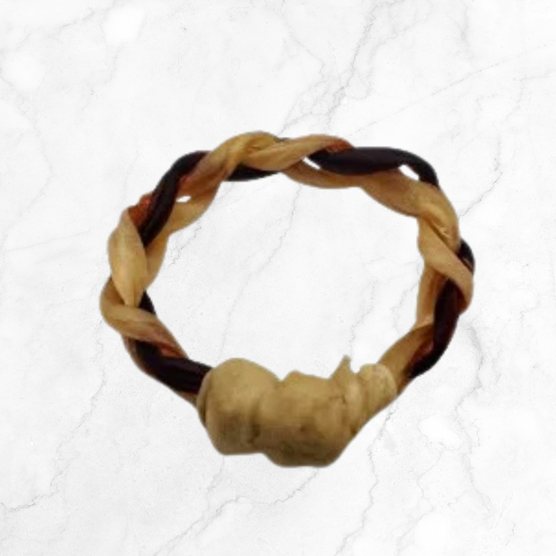 Braided dog toy with natural materials on a white background