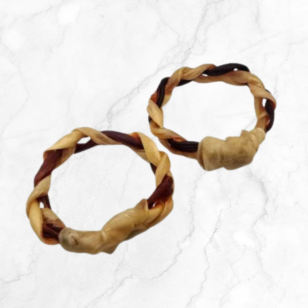 Two braided beef collagen rings dog chew on a white background