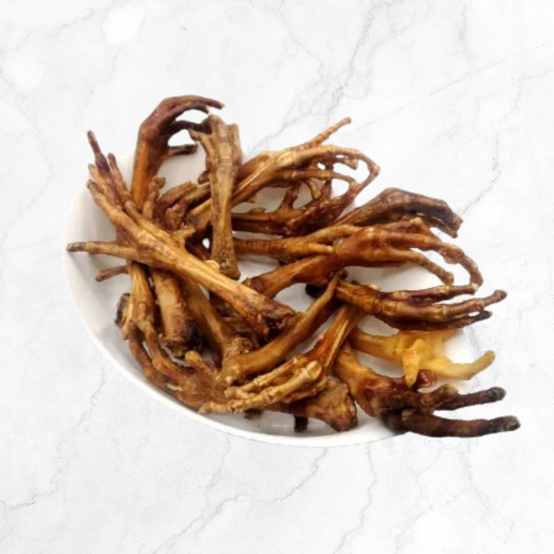 Dried chicken feet on a white plate with a white background