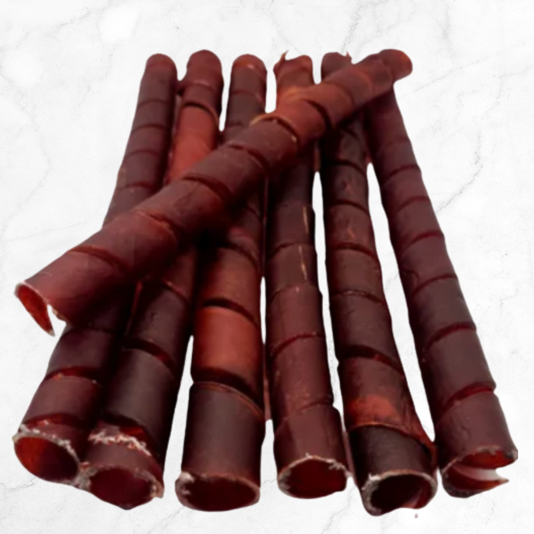 Red cylindrical dog treats on a white background