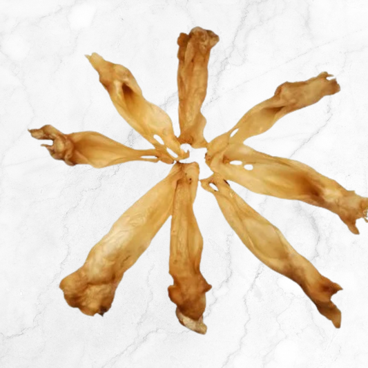 dehydrated goat ear dog chews arranged in a circular pattern on a white background