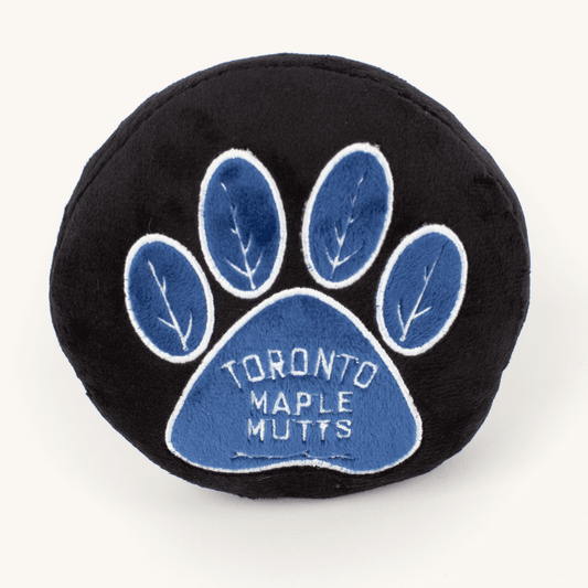 Black and blue paw-shaped pillow with 'Toronto Maple Mutts' text on a white background