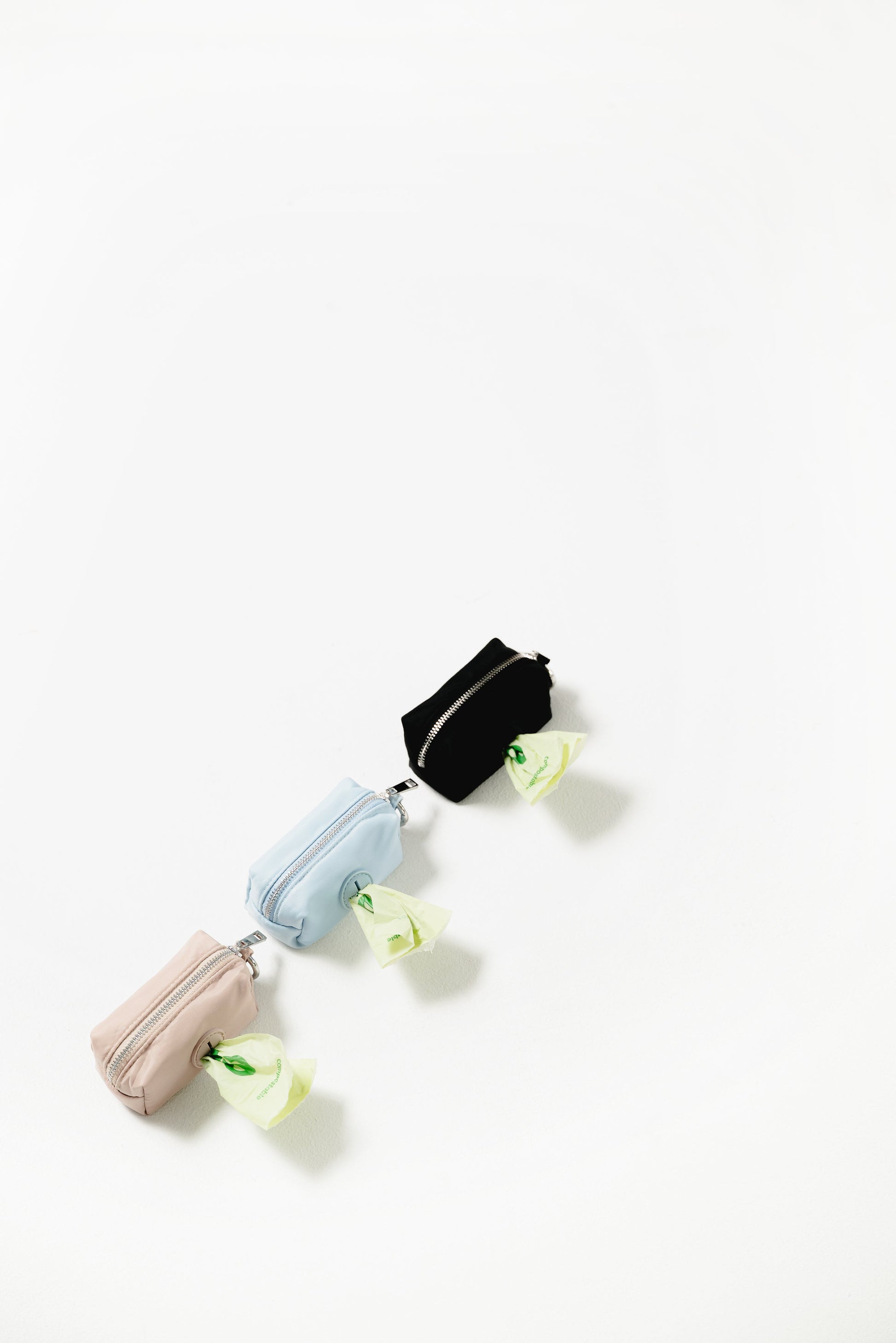 Noma Poop Bag Pouch poop bag dispenser from Floof Pet Products on a neutral background