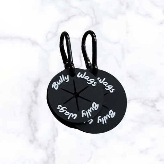 Three round poop bag clips in black colour with text on them, designed to attach to leashes or bags.